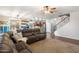 Open concept living room with hardwood floors and staircase leading to second floor at 12132 W Daley Ln, Sun City, AZ 85373