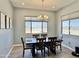 Well-lit dining room featuring a modern chandelier and large windows with mountain views at 12204 W Black Hawk Rd, Casa Grande, AZ 85194