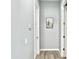 Neutral hallway with a framed picture of desert scenery and white trim at 12204 W Black Hawk Rd, Casa Grande, AZ 85194
