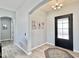 Entryway features an arched doorway, stylish rug, and decorative artwork at 12204 W Black Hawk Rd, Casa Grande, AZ 85194
