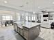 Gourmet kitchen island with seating and a farmhouse sink, open to the living space at 12204 W Black Hawk Rd, Casa Grande, AZ 85194