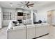 Open living area with built-in shelving, fireplace, and modern sectional sofa at 12204 W Black Hawk Rd, Casa Grande, AZ 85194
