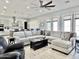 Bright living room showcasing a large sectional, ceiling fan, and contemporary accents at 12204 W Black Hawk Rd, Casa Grande, AZ 85194