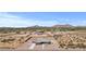 Expansive aerial view of a desert property featuring a modern home with mountain backdrop at 12204 W Blackhawk Rd, Casa Grande, AZ 85194