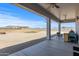 A covered patio overlooks the spacious backyard with gravel and mountain views, perfect for outdoor enjoyment at 12204 W Black Hawk Rd, Casa Grande, AZ 85194