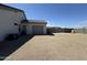 Side yard of a single Gathering home featuring stucco walls, a detached garage and desert landscaping at 12204 W Black Hawk Rd, Casa Grande, AZ 85194