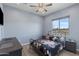 Cozy bedroom featuring a wrought-iron bed frame and a full view of the spacious backyard at 12204 W Black Hawk Rd, Casa Grande, AZ 85194