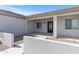 Inviting entrance with a covered porch, a dark wood door, and well-maintained landscaping at 12204 W Blackhawk Rd, Casa Grande, AZ 85194