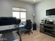 Bright home office featuring a desk, printer, treadmill, and a large window for natural light at 12204 W Black Hawk Rd, Casa Grande, AZ 85194