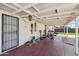 Covered back patio featuring workout equipment, a dog house, and a brick privacy wall at 13202 N 22Nd Ave, Phoenix, AZ 85029