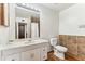 Bathroom with tile accents, a sink vanity, toilet, and a large mirror at 13202 N 22Nd Ave, Phoenix, AZ 85029