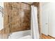 Bathroom shower with decorative tiles, shower head, and white shower curtain at 13202 N 22Nd Ave, Phoenix, AZ 85029