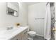 Bright bathroom featuring a modern vanity with a decorative mirror and a shower with a tiled enclosure at 13202 N 22Nd Ave, Phoenix, AZ 85029