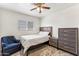 Comfortable bedroom with wooden furniture, ceiling fan, and soft carpeting at 13202 N 22Nd Ave, Phoenix, AZ 85029