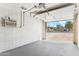 Spacious garage showcasing a cool air conditioning unit and a wide entrance to the driveway at 13202 N 22Nd Ave, Phoenix, AZ 85029