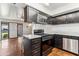 Well-lit kitchen with black cabinets, stainless steel appliances, island and marble countertops at 13202 N 22Nd Ave, Phoenix, AZ 85029