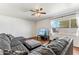 Living room featuring a comfy gray sofa, large window, and natural light at 13202 N 22Nd Ave, Phoenix, AZ 85029