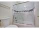 Bathroom with shower over tub with glass doors and marbled tile at 13236 N 13Th St, Phoenix, AZ 85022