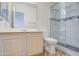 Bright bathroom features a glass enclosed shower, wood cabinets, and modern fixtures at 13236 N 13Th St, Phoenix, AZ 85022