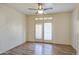 Spacious bedroom features light walls, wood floor and double doors with blinds at 13236 N 13Th St, Phoenix, AZ 85022