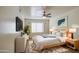 Cozy bedroom showcasing a ceiling fan, modern decor, and a plush rug for added comfort at 13236 N 13Th St, Phoenix, AZ 85022