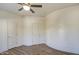 Bright bedroom with wood floors has two doors and a ceiling fan at 13236 N 13Th St, Phoenix, AZ 85022