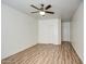 Empty room features neutral walls, wood flooring, two closets, and a ceiling fan at 13236 N 13Th St, Phoenix, AZ 85022