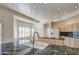 Bright kitchen featuring granite countertops, wood cabinets, and stainless steel sink at 13236 N 13Th St, Phoenix, AZ 85022