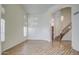 Bright, expansive living room with elegant wood floors, plantation shutters, and a view of the stairway at 13236 N 13Th St, Phoenix, AZ 85022