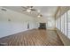 Large living room featuring a stone fireplace, neutral paint, and lots of windows with plantation shutters at 13236 N 13Th St, Phoenix, AZ 85022