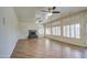 Bright living room featuring a fireplace, neutral paint, and lots of windows with plantation shutters at 13236 N 13Th St, Phoenix, AZ 85022