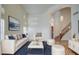 Inviting living room with a cozy seating arrangement, wood floors, and a view of the staircase at 13236 N 13Th St, Phoenix, AZ 85022