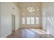 Bright living room with a large window, shutters, vaulted ceiling, and elegant chandelier at 13236 N 13Th St, Phoenix, AZ 85022