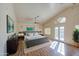 Beautiful primary bedroom with vaulted ceiling, ceiling fan, and french doors at 13236 N 13Th St, Phoenix, AZ 85022