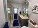 Bathroom with sink vanity, tiled shower, and blue accents at 1478 W Blackfoot Ave, Apache Junction, AZ 85119