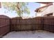 Small backyard enclosed by a privacy fence at 16402 N 31 St # 122, Phoenix, AZ 85032