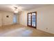 Bedroom featuring tan carpet, a ceiling fan, and wood doors that lead outside at 16402 N 31 St # 122, Phoenix, AZ 85032