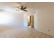 Bedroom featuring tiled floors, a ceiling fan, and ensuite bathroom at 16402 N 31 St # 122, Phoenix, AZ 85032