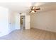 Bedroom with tiled flooring, ceiling fan and multiple entry doors at 16402 N 31 St # 122, Phoenix, AZ 85032