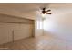 Bedroom with tiled floors, a ceiling fan, and a closet with a shelf at 16402 N 31 St # 122, Phoenix, AZ 85032