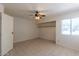 Bedroom featuring tiled floors, a ceiling fan, and open closet at 16402 N 31 St # 122, Phoenix, AZ 85032