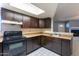 Kitchen featuring dark wood cabinets, matching appliances, tile floors, and a skylight at 16402 N 31 St # 122, Phoenix, AZ 85032