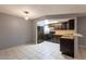 Well-lit kitchen with black appliances, wooden cabinetry, and open layout to the living area at 16402 N 31 St # 122, Phoenix, AZ 85032