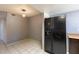 Kitchen eating area with black refrigerator and a view of the room's lighting at 16402 N 31 St # 122, Phoenix, AZ 85032