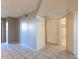 Living room with neutral paint, tiled flooring, and door into an adjacent room at 16402 N 31 St # 122, Phoenix, AZ 85032