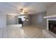 Open floor plan connecting the living area, kitchen, and a tiled fireplace, great for entertaining at 16402 N 31 St # 122, Phoenix, AZ 85032