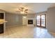 Living area featuring fireplace, French doors, tile floors, open layout, and gray walls at 16402 N 31 St # 122, Phoenix, AZ 85032