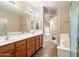 Bathroom featuring double sink vanity with wood cabinets, tile flooring, and a soaking tub at 16800 E El Lago Blvd # 2062, Fountain Hills, AZ 85268