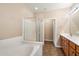 Bathroom featuring a tub, glass enclosed shower and a single sink vanity at 16800 E El Lago Blvd # 2062, Fountain Hills, AZ 85268