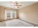 Cozy bedroom with ceiling fan, neutral walls, carpet and large window providing ample natural light at 16800 E El Lago Blvd # 2062, Fountain Hills, AZ 85268